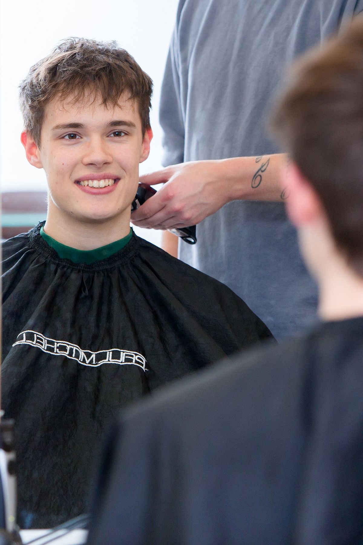Ein junger Mann beim Friseur.