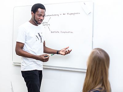A person at the whiteboard.